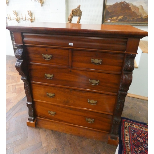 434 - A Victorian mahogany chest of four long and two short drawers with brass handles and carved side col... 