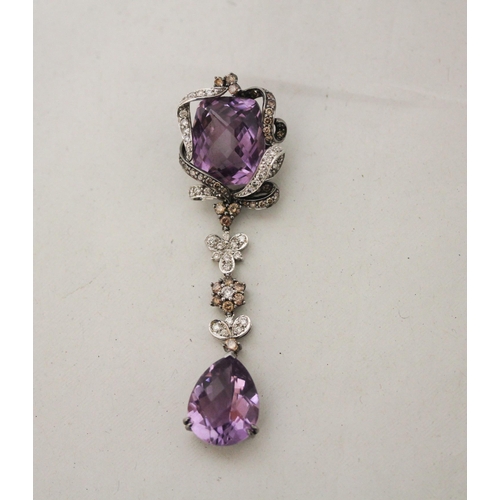 671 - A large modern amethyst and diamond pendant comprising two large mixed facet amethyst in a floral mo... 