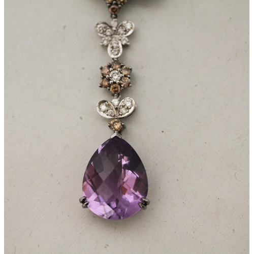 671 - A large modern amethyst and diamond pendant comprising two large mixed facet amethyst in a floral mo... 