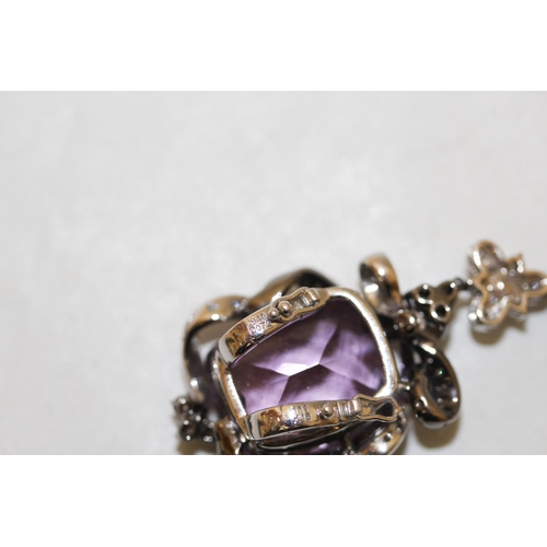 671 - A large modern amethyst and diamond pendant comprising two large mixed facet amethyst in a floral mo... 