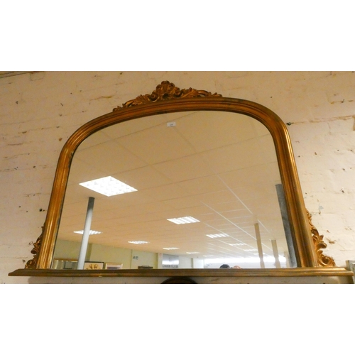 444 - A Victorian oval mantel mirror in a gilt frame. 46