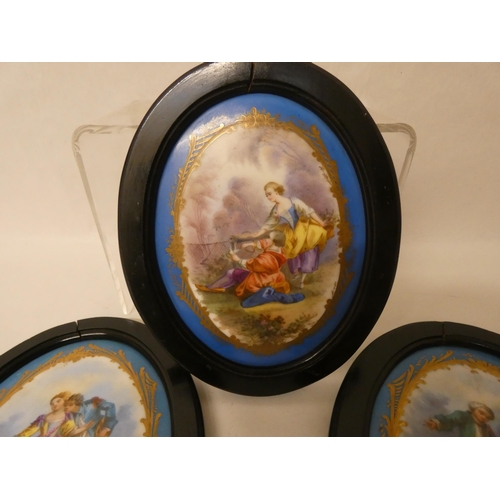 272 - A collection of three French porcelain plaques in the manner of Sevres in oval black frames approx s... 