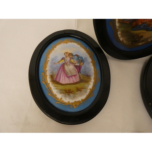 272 - A collection of three French porcelain plaques in the manner of Sevres in oval black frames approx s... 