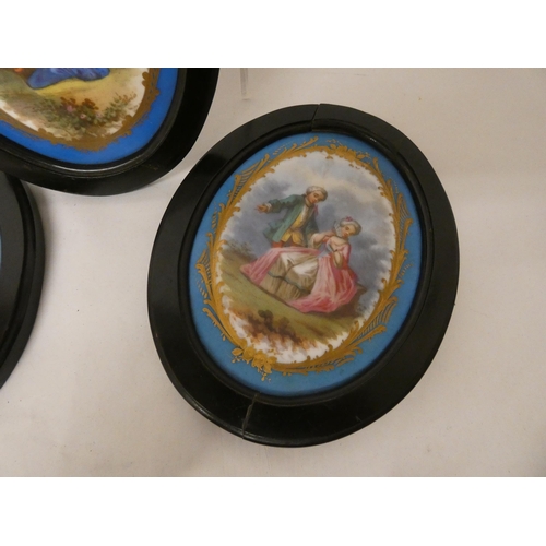 272 - A collection of three French porcelain plaques in the manner of Sevres in oval black frames approx s... 