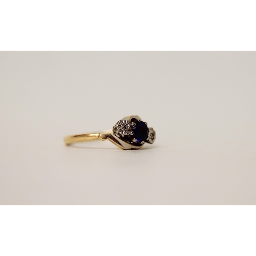 598 - A 18ct gold and platinum mounted three stone sapphire and diamond twist design ring, ring size M/N. ... 