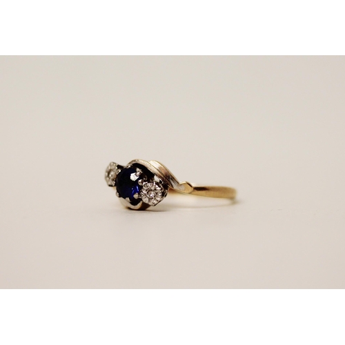 598 - A 18ct gold and platinum mounted three stone sapphire and diamond twist design ring, ring size M/N. ... 