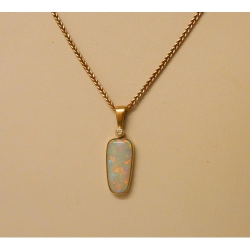 648 - An Australian boulder opal and diamond pendant set in 14ct gold, suspended from a 9ct rose gold chai... 