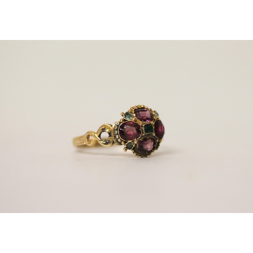 653 - An Antique 12ct gold almandine garnet and emerald cluster ring, set in a quatrefoil motif, hallmarke... 