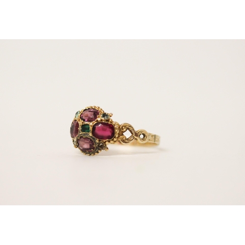 653 - An Antique 12ct gold almandine garnet and emerald cluster ring, set in a quatrefoil motif, hallmarke... 