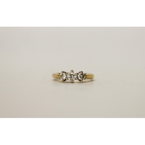 663 - A three stone diamond ring, on 18ct gold band, diamond weight 0.5 carat marked in band. Ring size H,... 