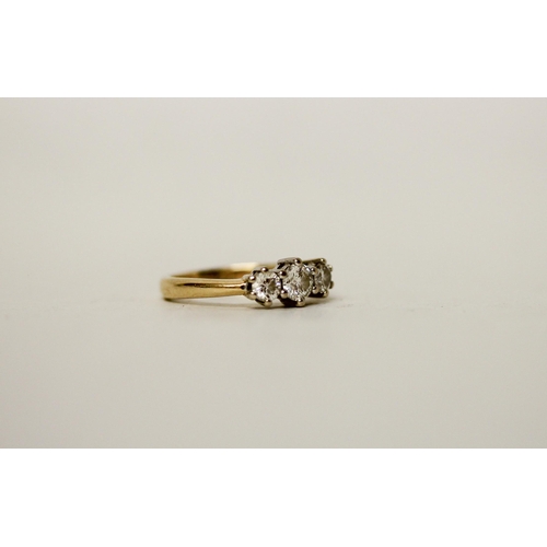 663 - A three stone diamond ring, on 18ct gold band, diamond weight 0.5 carat marked in band. Ring size H,... 