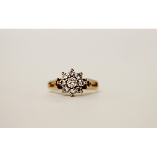 664 - A diamond daisy cluster ring, set nine brilliant cut diamonds in a floral design on hallmarked 18ct ... 