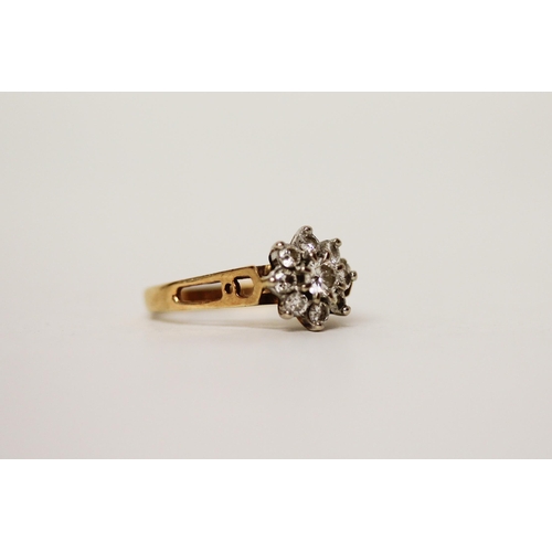 664 - A diamond daisy cluster ring, set nine brilliant cut diamonds in a floral design on hallmarked 18ct ... 