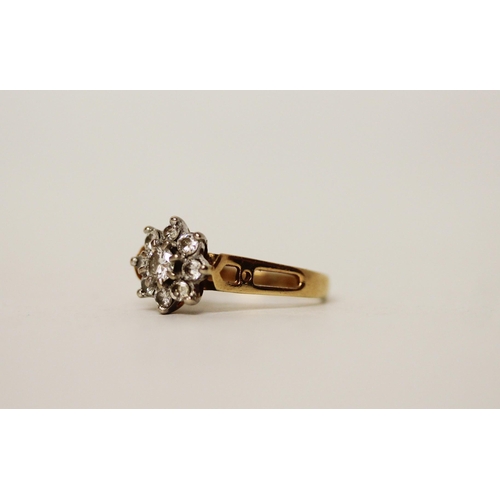 664 - A diamond daisy cluster ring, set nine brilliant cut diamonds in a floral design on hallmarked 18ct ... 