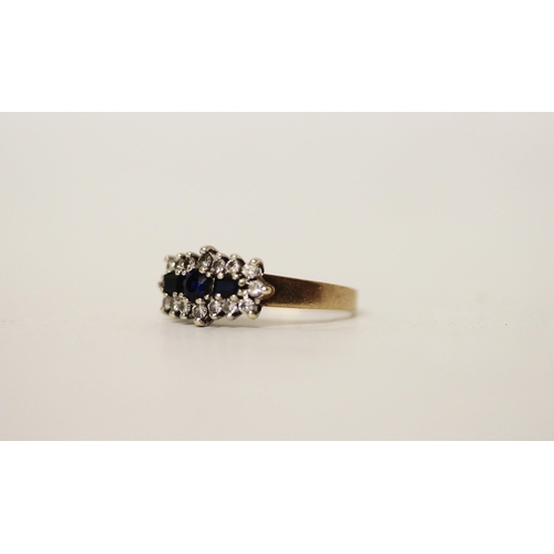 665 - A three stone sapphire and diamond cluster panel ring, on hallmarked 9ct yellow gold band. Ring size... 