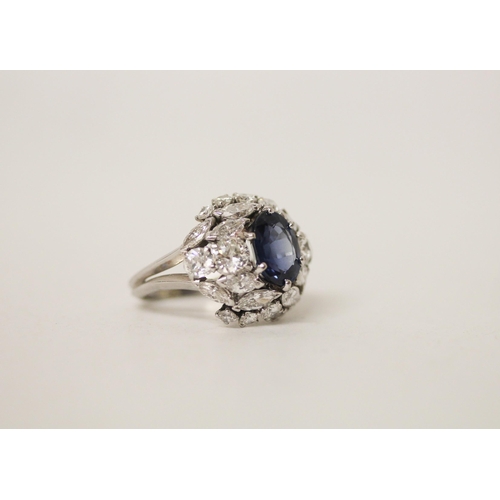 677 - A mid 20th century sapphire and diamond bombé ring, with an oval mixed cut sapphire claw set within ... 