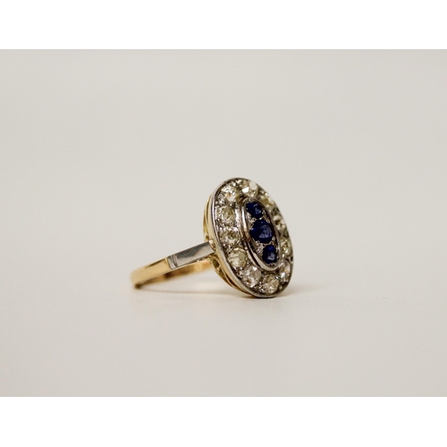 679 - An Art Deco oval sapphire and diamond ring, of oval form with three central sapphires in a millegrai... 