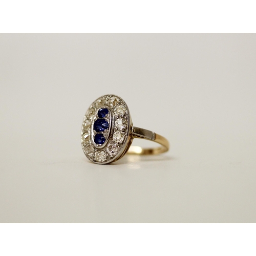 679 - An Art Deco oval sapphire and diamond ring, of oval form with three central sapphires in a millegrai... 