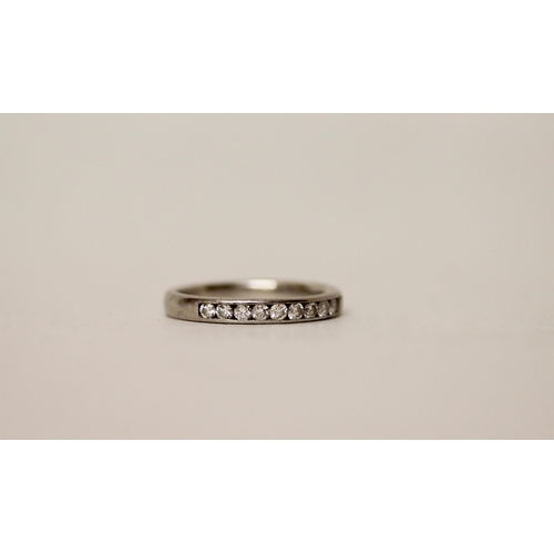 684 - A diamond half hoop eternity ring, in platinum. Unmarked. Gross weight 4g, ring size L