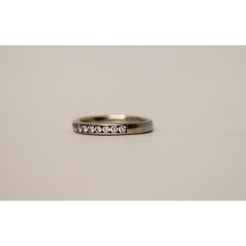 684 - A diamond half hoop eternity ring, in platinum. Unmarked. Gross weight 4g, ring size L