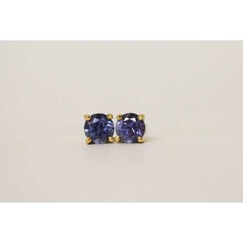 697 - A pair of tanzanite solitaire stud earrings, on 18ct yellow gold safety screw posts, gross weight 2g