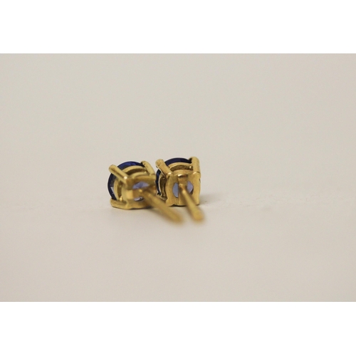 697 - A pair of tanzanite solitaire stud earrings, on 18ct yellow gold safety screw posts, gross weight 2g