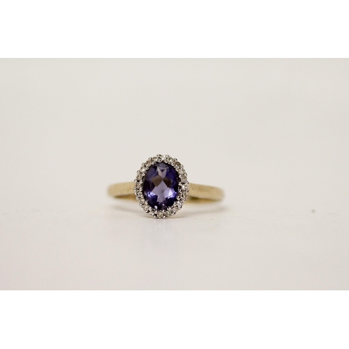 698 - A tanzanite and diamond oval cluster dress ring, on 9ct yellow gold band. Ring size P, gross weight ... 