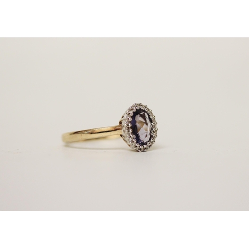 698 - A tanzanite and diamond oval cluster dress ring, on 9ct yellow gold band. Ring size P, gross weight ... 