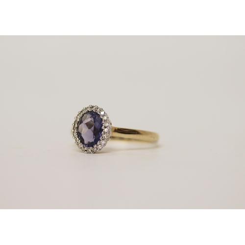 698 - A tanzanite and diamond oval cluster dress ring, on 9ct yellow gold band. Ring size P, gross weight ... 