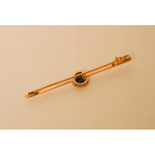 699 - A sapphire and diamond circular cluster bar brooch, on unmarked yellow gold pin. 4.1g