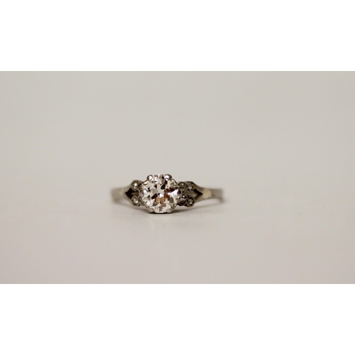 700 - An Art deco diamond engagement ring, claw set brilliant cut diamond on diamond shoulders, to a plati... 