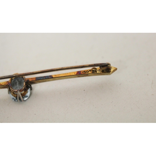 701 - An antique aquamarine bar brooch, with a single claw set aquamarine on 15ct gold bar. 69mm long, gro... 