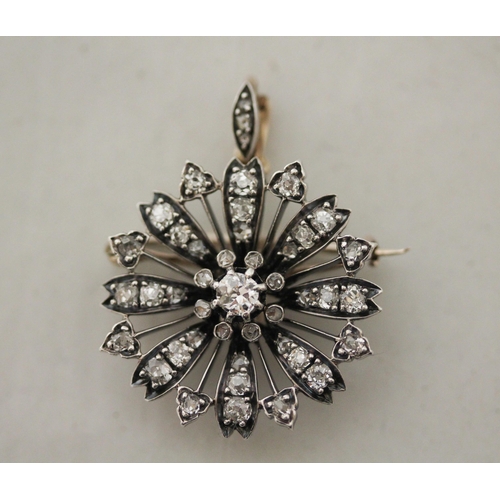 703 - A Victorian diamond flower cluster pendant / brooch of circular form, detachable brooch fitting to t... 