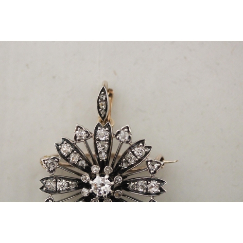 703 - A Victorian diamond flower cluster pendant / brooch of circular form, detachable brooch fitting to t... 