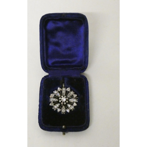 703 - A Victorian diamond flower cluster pendant / brooch of circular form, detachable brooch fitting to t... 