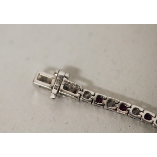 706 - A modern 9ct white gold ruby and diamond line bracelet. Hallmarked to the clasp, gross weight 5.5g, ... 