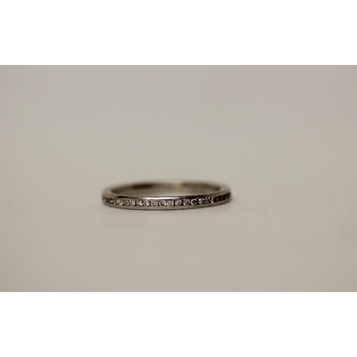 707 - A platinum half hoop diamond eternity or stacking ring. Hallmarked, ring size M, weight 3.3g