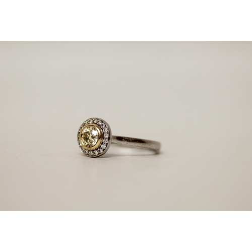 708 - A modern circular yellow diamond cluster ring, on hallmarked platinum shank. With a copy of GIA cert... 