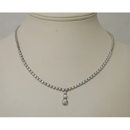 675 - A modern diamond necklace comprising brilliant cut diamonds in a line with a central three diamond d... 