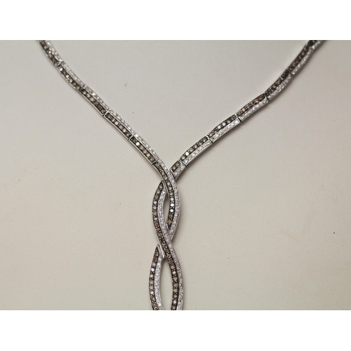 732 - A modern cognac and white diamond set necklace, all set in 14k white gold. Marked on clasp. Gross we... 