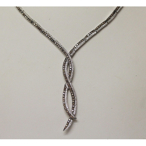 732 - A modern cognac and white diamond set necklace, all set in 14k white gold. Marked on clasp. Gross we... 