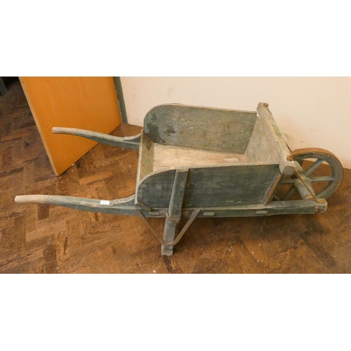 805 - A large old style wooden wheelbarrow. Could be used as an ornament or flower bed.