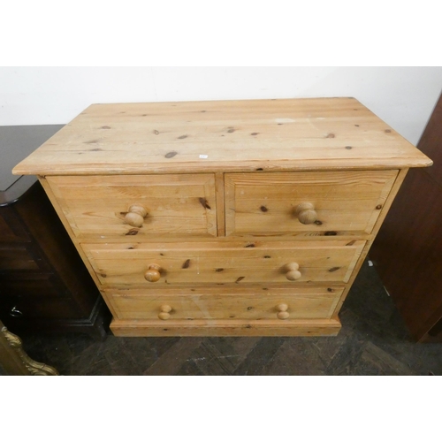 10 - A Victorian style stripped pine chest of two long and two short drawers with bun handles. 3' wide