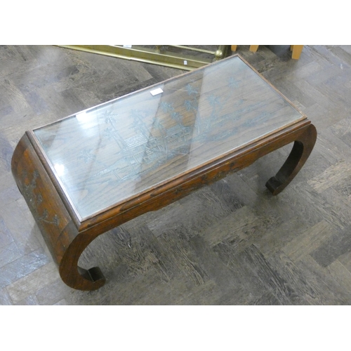 103 - A long carved Chinese hardwood coffee table with inset glass top