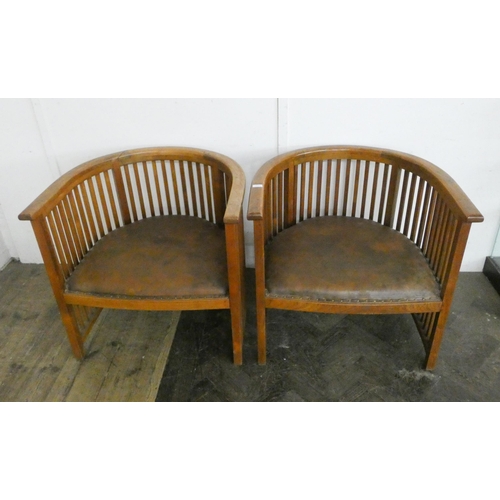 105 - A pair of very large teak tub shaped comb backed elbow chairs with leather upholstered seats