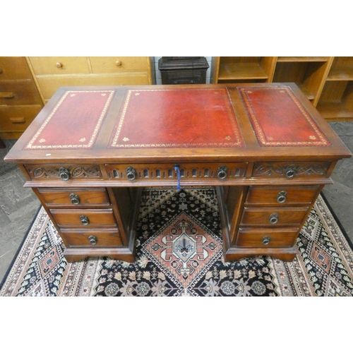 231 - A reproduction Victorian style oak pedestal desk, fitted nine drawers with red leather top. 4'3