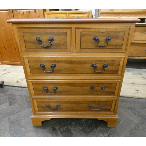 40 - A reproduction yew wood chest of three long and two short drawers with crossbanded top and drawer