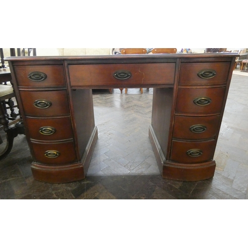 63 - A mahogany shaped front knee hole desk, fitted nine drawers with black leather top, 46