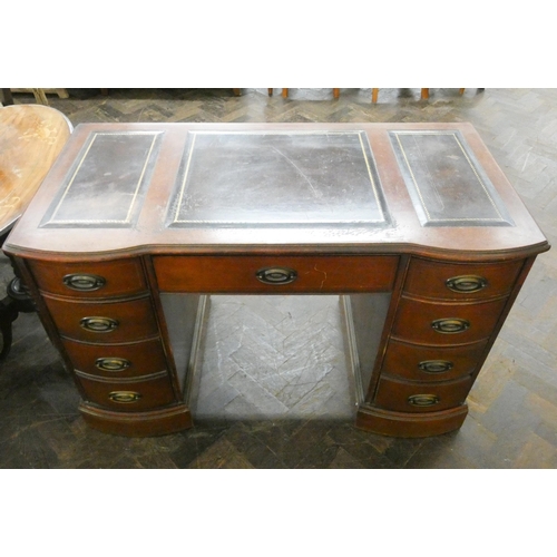 63 - A mahogany shaped front knee hole desk, fitted nine drawers with black leather top, 46