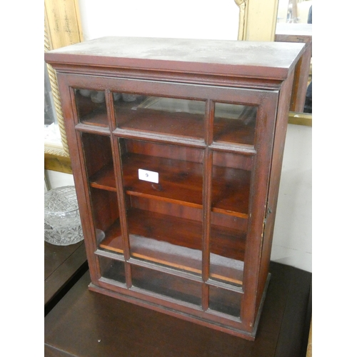 9 - A small mahogany glazed single door cabinet 21